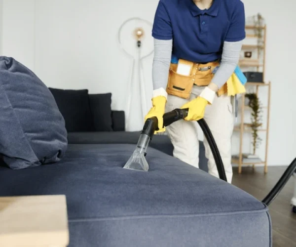 cleaning-service-worker-vacuuming-sofa-600nw-2301428931